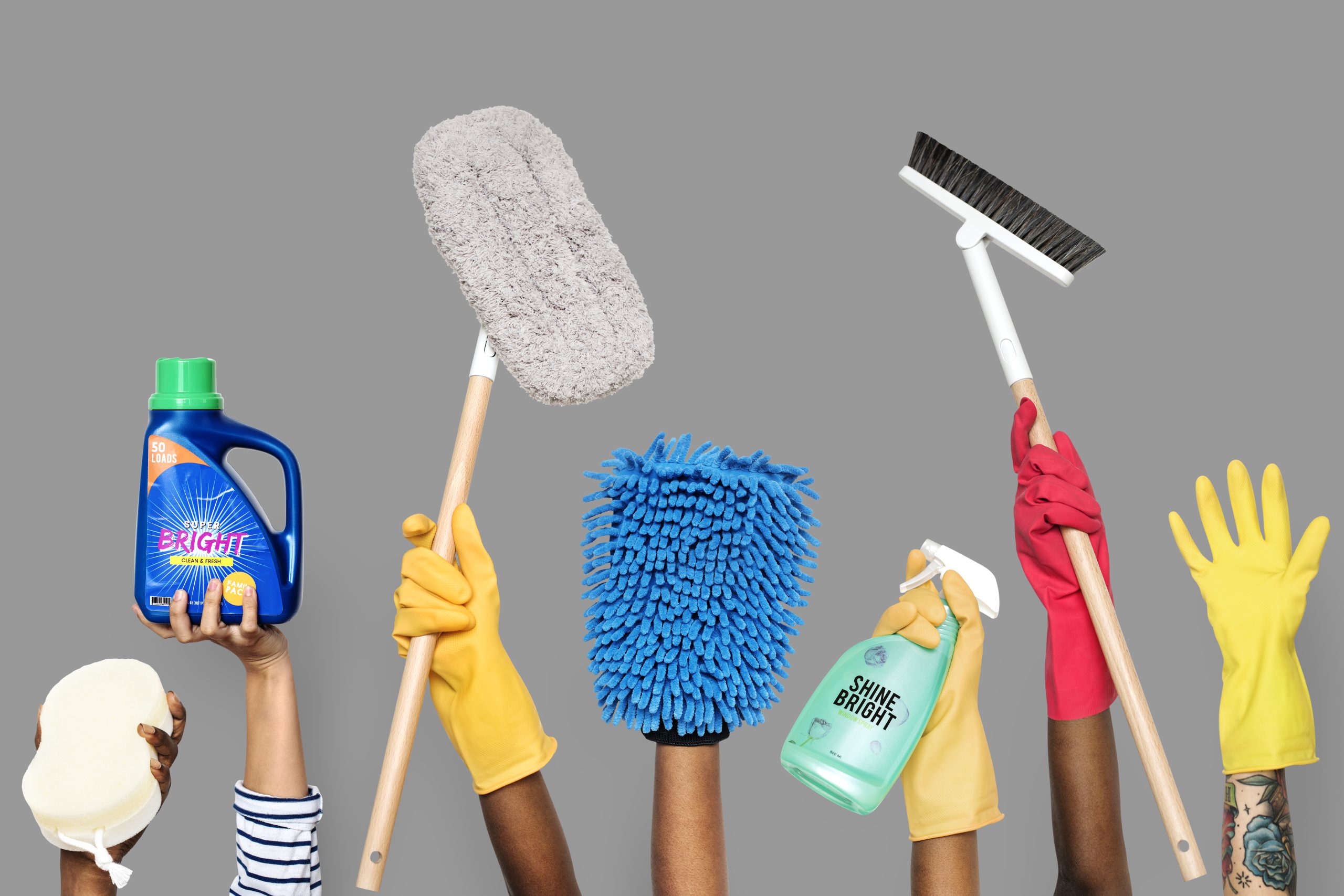 Hands holding cleaning tools and solutions